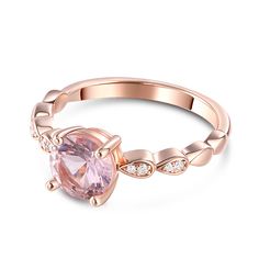 a rose quartz ring with diamonds on the band