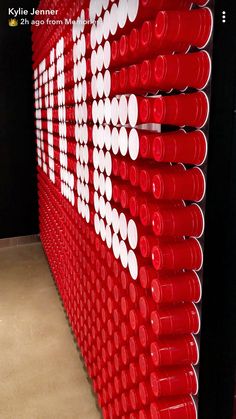 a red wall with white circles on it in a room next to a black wall