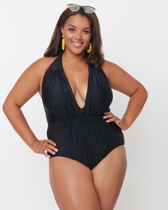 This stunning one piece swimsuit is a must-have for the season! Crafted with a ravishing black fabric that's shirred to flatter and smooth any imperfections, it features a plunging v-neckline and thick self tie halter neckline. The bottoms are lined in soft mesh for ultimate comfort while the top has extra lining on the back for security. Plus, you can enjoy a line free tan with its beautiful backless design - perfect for those hot summer days! Make a splash in this plus-size one-piece from our size-inclusive swimwear collection. Unique Vintage Unique Vintage Black Halter Shirred Derek One Piece Swimsuit | Black | Swimsuits | Materials & Care Instructions: ['82% Nylon, 18% Spandex', 'Hand wash', 'Imported'] Retro One Piece Swimsuits, Retro One Piece, Pin Up Swimsuit, Vintage One Piece, Unique Swimsuits, One Piece Swimsuit Black, Retro Swimwear, Bathing Suits One Piece, Vintage Plus Size