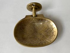 an antique brass pocket watch on a white background