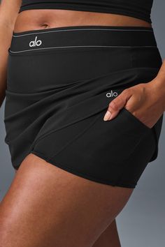 Take your look from the court to post-practice plans in the Match Point Tennis Skirt. It has a boxer-style elastic waistband (so on-trend), built-in shorts with a side pocket, and a mini-length hem. It’s made from a lightweight, slightly swishy performance fabric and has a cute, swingy fit. Wear it with a hoodie, a bra top, or even a blazer—this skirt aces the game every time. Athleisure Skort With Pockets For Gym, Athleisure Gym Skort With Pockets, Mini Skirt Activewear With Built-in Shorts For Workout, Activewear Mini Skirt With Built-in Shorts For Workout, Stretch Skort With Side Pockets For Sports, Stretch Skort With Pockets For Sports, Athleisure Sports Skort With Mini Skirt, Sporty Stretch Tennis Skirt With Side Pockets, Black Tennis Skirt With Built-in Shorts