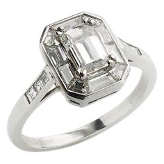 A modern diamond ring, centrally set with an emerald-cut diamond weighing an estimated 0.72ct, with a baguette-cut diamond mitre set border, with 0.11ct of square-cut diamonds set in the shoulders, mounted in platinum. Modern Diamond Ring, Diamond Cluster Rings, Pt School, Modern Diamond Rings, Platinum Diamond Rings, Cluster Rings, Baguette Cut Diamond, Platinum Ring, Diamond Cluster Ring