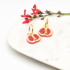 The porcelain fruit is handmade and hand painted. Each piece is unique and hand finished. Pomegranate size is 3x 2.7x 0.4 cm. The fruit is often seen as a symbol of fertility, prosperity and good luck. Hoop earring is made of sterling silver then plated with 18K gold.  Hoop size is 2 cm diameter. This earring is perfect for everyday wear. Perfect gift for both yourself and your loved one. Jewellery Care: Our jewellery is made from porcelain and should be treated as fragile. We recommend that customers should always remove your jewellery when applying scent, lotions and potions, or even better, always put your jewellery on last when getting dressed. Please note that chlorine is especially damaging to jewellery. Ensure that you rinse off any chemicals that come into contact with your jewelle Handmade Huggie Earrings As Gift, Handmade Dangle Huggie Earrings For Gifts, Handmade Small Hoop Huggie Earrings As Gift, Handmade Small Hoop Huggie Earrings For Gift, Handmade Red Hoop Earrings As Gift, Infinite Jewelry, Pomegranate Earrings, Earrings Hoop, Fun Earrings