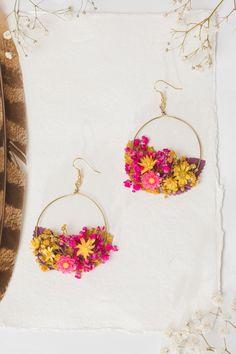 Wedding flower circle dangle earrings in magenta and yellow colours. Flowers/colours can be customised. Perfect for beach/exotic/tropical weddings, other events or just everyday use. The earrings are made of artificial flowers, preserved flowers, leaves and grass, wire, and other trinkets used for arranging :) Diameter: 6cm (2.5 inches) - weight 8-10g, length 8cm or 3cm (1.2 inches) - they weight only 5-8g. :) Please choose the material: 1. GOLD IMITATION HOOK (golden imitation wire/circle + gol Summer Dangle Jewelry With Flower Decoration, Pink Bohemian Jewelry With Pressed Flowers, Bohemian Pink Jewelry With Pressed Flowers, Handmade Flower Dangle Jewelry For Summer, Handmade Yellow Flower Earrings For Wedding, Bohemian Beaded Flower Earrings, Yellow Flower Earrings With Pressed Flowers, Yellow Flower-shaped Earrings With Pressed Flowers, Yellow Flower Earrings With Birth Flower Detail