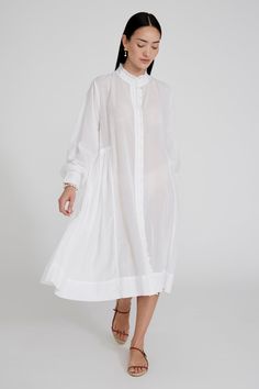 Cotton and viscose blend button down dress with ruffled details and balloon sleeves. 55% Cotton, 45% Viscose. 22.5" Bust, 23" Sleeve, 54.5" Bottom Width, 51" Total Length. One size: Fits sizes S-L. Machine wash cold. Made in India. Voluminous Bishop Sleeve Spring Dress, Spring Voluminous Bishop Sleeve Dress, Voluminous Bishop Sleeve Dresses For Spring, Spring Daywear Puff Sleeve Dress With Bishop Sleeves, Summer Voluminous Dresses With Bishop Sleeves, Spring Puff Sleeve Dress With Bishop Sleeves For Daywear, Spring Puff Sleeve Dress With Button Cuffs For Work, Spring Workwear Puff Sleeve Dress With Button Cuffs, Spring Daywear Midi Dress With Balloon Sleeves