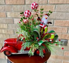 an old red truck with christmas decorations in it