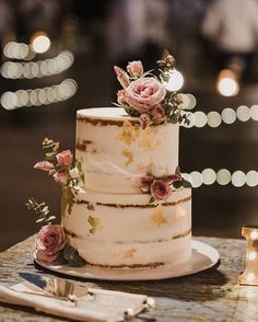 a wedding cake with pink flowers on top