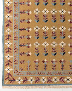 a brown rug with blue and red designs on it