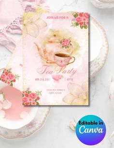 a pink tea party card with flowers and a teapot on it, next to some plates