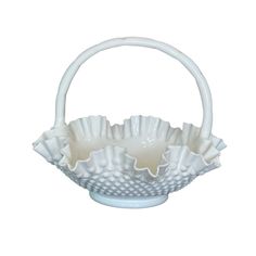 a white basket with three cups in it