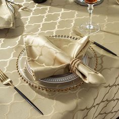 an elegant table setting with silverware and napkins