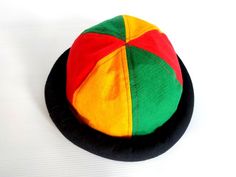 This Rasta Jamaican Bucket hat is perfect for Summer Reggae Festivals. This solid Bucket hat features a Jamaican Rasta Inspired Striped Band atop a solid , Red green yellow Rasta color bucket hat. Rock this hat as you dance the night away at your next outdoor concert or event. Fashionable and a must-have . This Hat is unisex that looks great on both men and women . This Hat is very durable and can be used as a special gift . -Solid Unisex Jamaican Adult Sun Hat -Rasta Reggae Inspired Striped Ban Adjustable Multicolor Costume Cap, Adjustable Multicolor Wide Brim Cloche Hat, Multicolor Short Brim Bucket Hat, Multicolor Short Brim Mini Hat, Adjustable Brimmed Cloche Hat For Festival, Multicolor Adjustable Fitted Hat With Curved Brim, Adjustable Multicolor Fitted Hat With Curved Brim, Retro Adjustable Costume Hat, Retro Brimmed Festival Hat