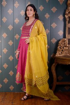 Magenta anarkali with floral foil print and lace trim on the neckline and sleeve hems. Comes with straight pants and mustard yellow chanderi dupatta.
Component: 3
Pattern: Print and Embroidery
Type Of Work: Foil Print, Sequin and Thread
Neckline: Round
Sleeve Type: Full
Fabric: Anarkali: Banarasi Chanderi, Pant: Cotton Satin and Dupatta: Chanderi
Color: Magenta
Other Details: 
Floral print dupatta with scalloped border
Lace trim on the neckline, bodice and sleeve hem
Occasion: Puja - Aza Fashion Magenta Anarkali, Chanderi Dupatta, Print And Embroidery, Border Lace, Scalloped Border, Color Magenta, Foil Print, Straight Pants, Set For Women