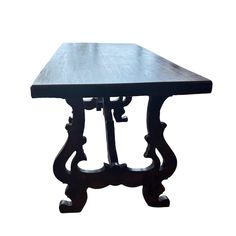 a wooden table with an intricate design on the top and bottom, against a white background