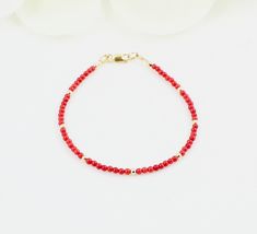 This red minimalist bracelet made of tiny red coral and faceted natural gold polished hematite stones.Simple and timeless. Materials - 2.2-2.3 mm round red coral stones. - 2.5 mm gold filled beads - 14K gold filled clasp.Spring ring clasp OR Lobster claw clasp. Please see last picture and select the one you like using the drop down menu. Bracelet Length Options - from 6.5 to 8.5 inches If you prefer smaller or larger size, please contact me about custom sizing. The necklace will be packed in a j Minimalist Red Beaded Bracelet With Tiny Beads, Dainty Red Beaded Bracelets With Tiny Beads, Red Faceted Beaded Bracelets For Gifts, Red Beaded Dainty Bracelets, Red Faceted Round Bead Bracelets, Red Minimalist, Black Spinel Bracelet, Red Bracelet, Bracelet Stacking