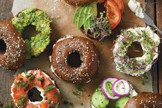 an assortment of bagels with different toppings