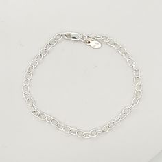 This Silver Charm Bracelet is a stylish and versatile accessory for women. Made of high-quality .925 sterling silver, this bracelet adds a touch of elegance to any outfit. With its simple yet eye-catching design, it is perfect for everyday wear or special occasions. Enhance your style with this must-have piece. The bracelet is 7" long, and charms are sold separately. Classic Silver Chain Charm Bracelet, Classic Silver Chain Bracelet For Everyday, Classic White Gold Charm Bracelet With Silver Chain, Classic Silver Chain Charm Bracelet With Oval Links, Classic Silver Chain Bracelet, Classic Silver Charm Bracelet For Everyday, Classic Bracelet With Sterling Silver Clasp As Gift, Elegant Sterling Silver Bracelet With Extender For Everyday, Sterling Silver Bracelet With Silver Chain For Everyday Wear