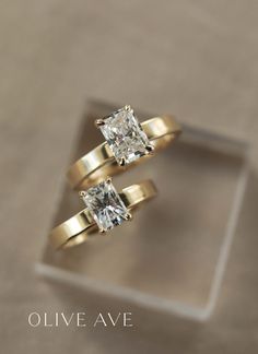 two yellow gold engagement rings with a princess cut diamond