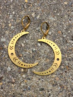 beautiful crescent moon brass earrings perfect for the moon lover in all of us.  these golden  brass moons have simple designs cut out from them giving them a cool and modern feel. these lightweight earrings are made from brass  which will naturally tarnish over time giving them a  super cool antiqued look.  they are made with  golden brass earwires. please scroll thru photos to see size in relation to the quarter i have shown them with. crescent moon earrings / cut out moon design earrings / br Gold Half Moon Shaped Metal Jewelry, Half-moon Metal Earrings With Moon Charm, Metal Half Moon Earrings With Moon Charm, Half Moon Metal Earrings With Moon Charm, Half Moon Earrings With Moon Charm, Gold Moon Shaped Metal Hoop Earrings, Gold Moon-shaped Metal Hoop Earrings, Gold Crescent Earrings With Moon Phase Detail, Gold Moon Shaped Hoop Earrings