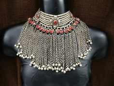 This is an Afghan kuchi tribal choker necklace. It's an old handmade Afghan Turkish banjara vintage necklace. You can not go unnoticed at any occasion while wearing it. Its a beautiful peace of art created by the tribal people, all handmade. The length of the necklace is 13 inches and with the red rope is 19 inches The height of the necklace is 7 inches from top to bottom. Please give room for some minor imperfections as its all handmade. There may be some patina also due to the age as it's a vi Bohemian Necklace With Silver Beads For Ceremonial Use, Bohemian Metal Choker For Ceremonial Use, Traditional Choker Necklace For Festivals, Bohemian Metal Choker For Ceremonial Occasion, Bohemian Handmade Choker For Rituals, Handmade Bohemian Choker For Rituals, Bohemian Heavy Choker Necklace, Bohemian Heavy Necklace For Festival, Traditional Boho Collar Necklace For Festivals