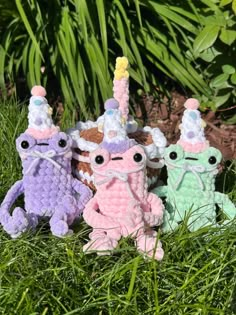 three crocheted stuffed animals sitting in the grass