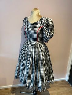 Vintage 1950's gingham dress, 50's handmade gingham dress, 50s swing dress with puff sleeves. UK 6 - 8 A vintage 1950's handmade gingham dress with puff sleeves. It has a metal zip down the centre back. There is no fabric label but it feels like cotton or a polycotton. Wear with a underskirt (not included) for that 50's full skirt look. It will fit a size 6 - 8, but please check measurements. The waist and hips are generous but the chest is measuring a size 6, so check your chest measurement. UK Fitted Retro Vintage Dress For Picnic, Fitted Retro Plaid Vintage Dress, Fitted Plaid Retro Vintage Dress, Retro Plaid Dresses For Picnic, Retro Plaid Fitted Vintage Dress, Vintage A-line Plaid Dress, Retro Plaid Dresses For Vintage Fashion, Plaid Vintage Summer Dress, Summer Plaid Vintage Dress