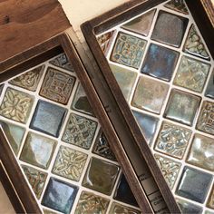 two wooden frames with decorative tiles on them, one is open and the other is closed