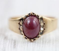 "L-651  AMAZING ANTIQUE SOLID 14K GOLD RING, SET WITH A NATURAL RUBY CABOCHON. EARLY BEZEL SETTING , SIMPLE SIDES. THE RUBY HAS ABRASIONS AND SCRATCHES. BEAUTIFUL DESIGN, WONDERFUL HIGHEST QUALITY. JUST PART OF MY MOST RECENT ESTATE FINDS! FOLLOW ME TO SEE THEM ALL!   Brand: Georgian Ruby Cabochon Metal: 14K Yellow Gold Metal Purity: 14K Material: Ruby Ring Size: 7.75 Other Dimensions: 1/2\" Form: Solitaire Ring Luxury Age: Antique Weight (Grams): 3.4g IT IS IN EXCELLENT ESTATE CONDITION  ALL IT Formal Fine Jewelry Signet Ring With Cabochon, Formal Cabochon Signet Ring, Classic Ruby Ring With Round Stone For Formal Occasions, Classic Ruby Ring With Polished Round Stone, Classic Yellow Gold Signet Ring With Cabochon, Classic 14k Gold Signet Ring With Cabochon, Formal Cabochon Ruby Ring, Classic Ruby Ring With Polished Finish For Collectors, Vintage Signet Ring With Cabochon For Anniversary