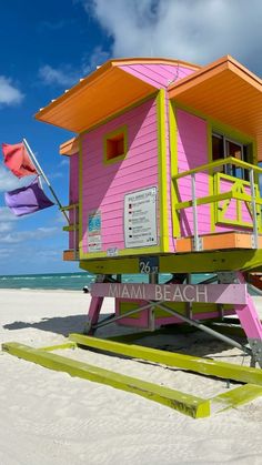 a life guard stand on the beach with an umbrella