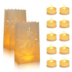 several lit candles sitting next to small bags