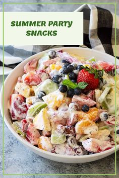 a white bowl filled with fruit salad on top of a table