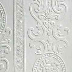 white wallpaper with intricate designs and circular design on it's side, as well as an ornate border