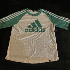 Adidas Green T-Shirt With Green Stripes On Sleeves Size Large Never Worn Casual Summer T-shirt With Three Stripes, Adidas T-shirt For Spring Streetwear, Casual Green T-shirt With Adidas Logo, Green Logo Print T-shirt For Spring, Adidas Three Stripes Crew Neck T-shirt, Basic Crew Neck T-shirt With Three Stripes, Adidas Three Stripes T-shirt For Spring, Casual T-shirt With Three Stripes Branding For Spring, White 90s Style Crew Neck Top