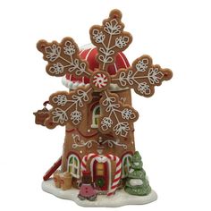 a gingerbread house decorated with candy canes and snowflakes