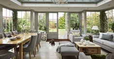 a living room filled with furniture and lots of windows