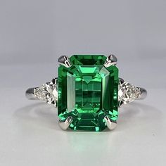 "The ring pictured is emerald cut emerald This ring can be made with many different stone colors Message us for pricing on different color/type stones Emerald is the birthstone of May for emerald earrings click here: https://etsy.me/3AN4nqW for emerald rings click here: https://etsy.me/3JIov0a for emerald pendants click here: https://etsy.me/3Td2gnv -Approximate total carat weight:  3.95ctw. diamond equivalent  -Center Stone Size:  10x8mm approx. 3.55ct diamond equivalent -Center Stone Shape: em 5 Carat Emerald Ring, Emerald Pendants, Emerald Stone Rings, Engagement Ring Emerald Cut, Emerald Cut Engagement Ring, Engagement Ring Emerald, Emerald Ring Vintage, Extraordinary Jewelry, Ring Emerald Cut