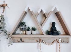 two wooden shelves with plants and decorations on them