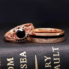 two wedding rings sitting on top of a book