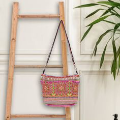 Designed with colorful Hmong cross-stitching, Nuchsuwan's sling bag is a wonderful example of Hmong hill tribe handicrafts in Thailand. Hand crafted from a poly-cotton blend, the bag features a striped hill tribe pattern, an adjustable strap, and a zippered closure. Lined in black cotton, the interior includes one open pocket and one zippered. Thailand Gifts, Hmong Fashion, Learning To Embroider, Selling On Instagram, Gift Suggestions, Beautiful Handbags, Cross Stitching, Free Gift Wrapping, Sling Bag