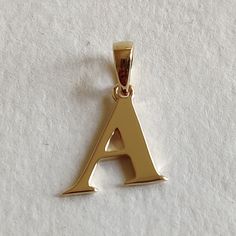 This is an exquisite initial charm pendant set in 14K Solid Gold.  An elegant design, perfect for any occassion. ITEM DETAILS: ✓ Letter : A ✓ Gold Kt: Solid 14K Yellow Gold ✓ 14 K Gold Weight : 1.10 grams ✓ Gross Weight: 1.10 grams >>The Gold purity is guaranteed and it comes with authentic 14K gold hallmark. >>A-Z letters available on my Etsy Shop. CUSTOMER SUPPORT: We are available 24/7 to respond to all your queries! PACKAGING: The pendant comes in layers of safe and secure wrapping along with a free Handmade Jewelry Box. Birthday Gift Letter, Gift Letter, Gold Initial Pendant, Initial A, Alphabet Necklace, Alphabet A, Handmade Jewelry Box, Bezel Pendant, Gold Initial