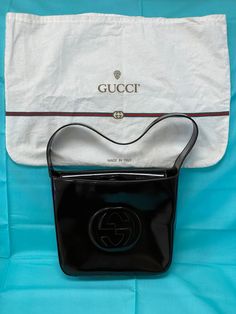 **Includes original Gucci dust bag and inside paperwork. *Pre-owned  10X8.5X3 Id 000-0506 200110 Introducing the Vintage Gucci Soho Patent Leather Brown Shoulder Bag, a timeless piece that exudes elegance and sophistication. Crafted from luxurious patent leather, this bag features a rich brown hue that effortlessly complements any outfit. The signature interlocking GG logo embossed on the front adds a touch of iconic Gucci flair. This shoulder bag is designed for both style and functionality. Its spacious interior offers ample room for all your essentials, while the zip-top closure ensures your belongings are secure. The comfortable leather shoulder strap makes it easy to carry, whether you're heading to a casual brunch or an evening event. The Vintage Gucci Soho Patent Leather Brown Shoul Luxury Gucci Evening Shoulder Bag, Luxury Casual Gucci Hats, Luxury Patent Leather Evening Bag, Casual Luxury Gucci Hats, Luxury Brown Gucci Hat, Luxury Embossed Logo Shoulder Bag For Evening, Casual Gucci Hats Luxury, Gucci Soho, Gucci Brand