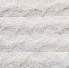 a white brick wall textured with cement