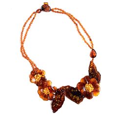 Polish Designer Baltic Amber Flower Necklace Beautifully designed with high quality large hand cut cognac stones! Beautiful Cognac Slices and Flowers for a Unique Look. Stones: Baltic Amber Length: Necklace is approx. 20" in length Width: Largest flower approx. 2" long x 1 3/4" wide Material: Cotton Thread Made in: Poland Alexandrite Jewelry, Flower Statement Necklace, Stone Statement Necklace, Baltic Amber Jewelry, Amber Gemstone, Silver Necklace Statement, Rose Gold Diamond Ring, Length Necklace, Casting Jewelry