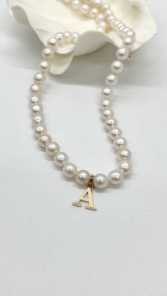 This pearl necklace with initial letter is an elegant, unique necklace. Perfect as a personalized gift for your daughter, wife, mom or friends!  The pearl is natural with size of 5-6mm approximately and the letter is made of 10K or 14K  solid gold and finish with gold lobster clasp.  Strung and knotted in between for bead preservation . Made in Montréal Canada 🇨🇦  Details: Gold: 10K 14K Solid Gold Pearl: White Freshwater Pearl  Size: 5-6mm approximately  Length: 16-18 inches  Condition: New Se Classic Initial Necklace As A Gift, Classic Personalized Pearl Jewelry, Classic Initials Name Necklace For Anniversary, Classic Letter Beads Jewelry As Gift, Classic White Initial Pendant Necklace, Classic Letter Beads Jewelry Gift, Classic Personalized Initial Necklace For Anniversary, Classic Round Pearl Necklace For Mother's Day, White Monogram Necklace For Anniversary