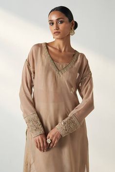 Beige and brown full sleeves kurta with bloom embroidery on the neckline and sleeves hem. Paired with a pant and a shimmery striped bustier. - Aza Fashions Beige Long Sleeve Sets With Embroidered Border, Brown Sets With Resham Embroidery And Long Sleeves, Brown Long Sleeve Sets With Resham Embroidery, Elegant Long Sleeve Brown Kurta, Brown Long Sleeve Kurta With Chikankari Embroidery, Beige Embroidered Long Sleeve Kurta, Elegant Embroidered Brown Kurta, Bloom Embroidery, Organza Embroidery