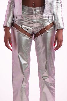 Ariana Cut Out Pants Key Features: Silver grommets Looped chains Chrome accents Breathable, smooth fabric Cutout detailing 5-pocket design Zip fly with button closure Made in the USA Details: The Ariana Cut Out Pants feature striking silver grommets and looped chains that enhance their edgy design. Crafted from breathable and smooth fabric, they ensure comfort and a polished look. With cutouts for added flair and utility pockets for convenience, these pants blend style with functionality. Conten Luxury Party Bottoms With Belt Loops, Painted Pants, Edgy Design, Denim Outerwear, Utility Pockets, Fly Girl, Girl Blog, Turks And Caicos Islands, Easy Wear