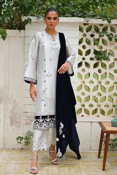 This ensemble showcases a long tissue shirt in a metallic silver hue with a cutwork neckline and composed embroidery. Bird motifs and the navy blue velvet dupatta add a charming element to the ensemble. Pair it with matching rawsilk culottes with worked borders. Embroidery Bird, Sania Maskatiya, Velvet Dupatta, Navy Blue Velvet, Pakistani Dress, Bird Motif, Website Features, Pakistani Dress Design, Pakistani Suits