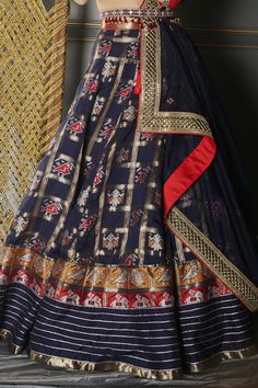 Midnight blue pure silk woven patola lehenga. Comes with ruby red blouse in puff sleeved hand embroidered details and organza laced dupatta paired with semi-precious jewelled kamarbandh with tassels.
Components:4
Pattern:Embroidered
Type of Work:Resham, Zardozi, Mirror and Gota
Neckline:Square
Sleeve Length:Puff Sleeves
Fabric:Lehenga and Blouse: Pure Silk Banarasi; Dupatta: Organza
Color:Blue
Other Details:
Cutwork hem neckline
Patola motifs
Tassel hem belt
Note: The potli bag shown in the imag Raw Silk Sets With Motifs For Reception, Festive Silk Sets With Pallu, Indigo Navratri Set With Dupatta, Unstitched Cotton Silk Choli For Festivals, Indigo Sets With Dupatta For Navratri, Silk Anarkali Set For Navratri And Traditional Ceremonies, Festive Silk Choli With Traditional Drape, Silk Sets With Cutdana For Festivals, Cotton Silk Choli With Zari Work For Festivals