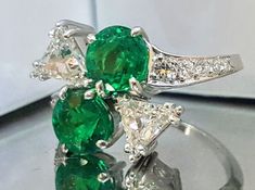 Gorgeous Vintage Diamond & Emerald in Platinum ring circ 1940's center two round natural green emerald weight 2.45ct SIZE 7mm rich grass green color ,very brilliant clean very lively stones . side two natural trillion diamonds weight 0.90ct.VS1-H Side Set Natural Round Diamonds Weight 0.35ct. Ring size 8 This tremendous old vintage ring is in a very good condition. Fabulous vintage piece in good condition Appraisal available Vintage Emerald Ring With Vvs Clarity, Vintage Green Emerald Ring Gia Certified, Grass Green Color, Vintage Engagement Rings Round, Platinum Engagement Rings Vintage, Trillion Diamonds, Emerald Ring Vintage, Emerald Diamond Ring, Engagement Rings Round