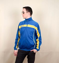 The stylish retro windbreaker will be a perfect and comfortable addition to your old-school-inspired rave and streetwear clothing. Unique blue 90s vintage windbreaker shell jacket for men. Good quality vintage sports tracksuit bomber jacket closes with a zipper on the front, has two pockets, and an elastic waist. ▼ D e s c r i p t i o n ▼ BRAND: Royal MADE IN: France CONDITION: Excellent Vintage. COLOR: Blue, yellow MATERIAL: Polyester FITS LIKE: Marked size L. Fits like M - L, but please refer Retro Cotton Track Jacket For Streetwear, Retro Long Sleeve Track Jacket For Sports Events, Retro Hooded Track Jacket For Streetwear, Retro Hooded Track Jacket For Sports, Retro Cotton Track Jacket For Outdoor, Retro Long Sleeve Track Jacket For Streetwear, Retro Cotton Windbreaker For Streetwear, Retro Blue Track Jacket For Streetwear, Retro Blue Track Jacket For Sports